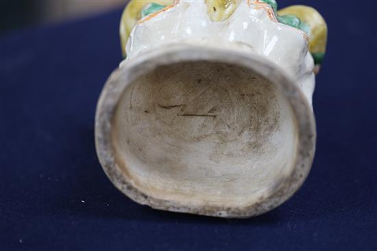 A Chinese Sancai glazed pottery seated figure of Guanyin, Qing dynasty, H.27cm, some flaking to glaze